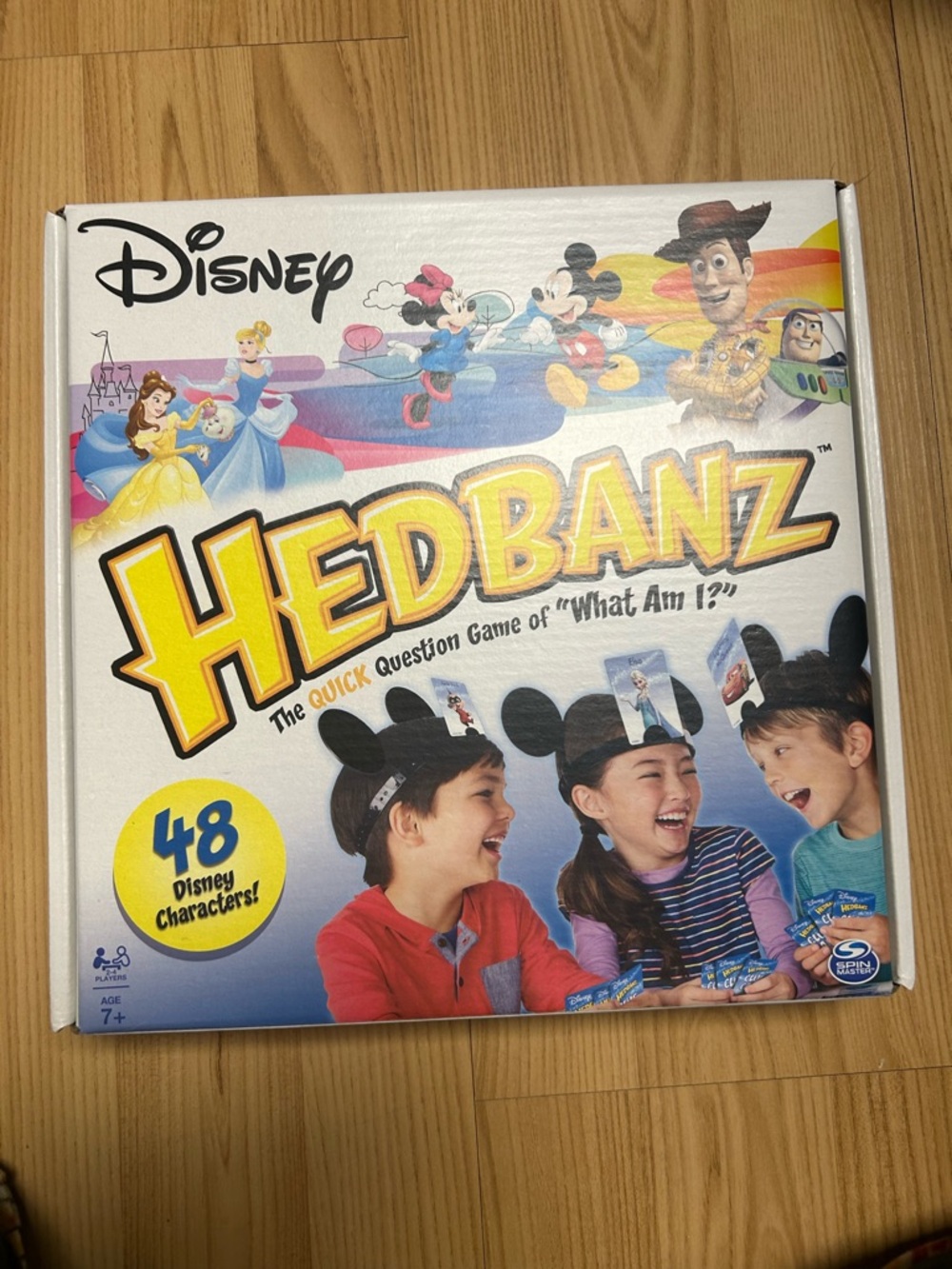 Disney Hedbanz Game Box – White with Yellow Logo and Multicolor Art